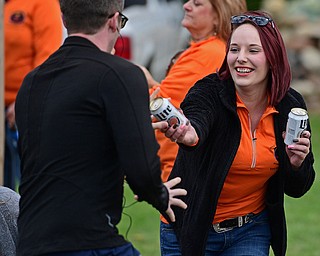YOUNGSTOWN, OHIO - OCTOBER 23, 2016: Emily Dunn of Youngstown hands a cool beer to a unidentified runner near the starting line at the start of the Peace Race, Sunday morning. DAVID DERMER | THE VINDICATOR