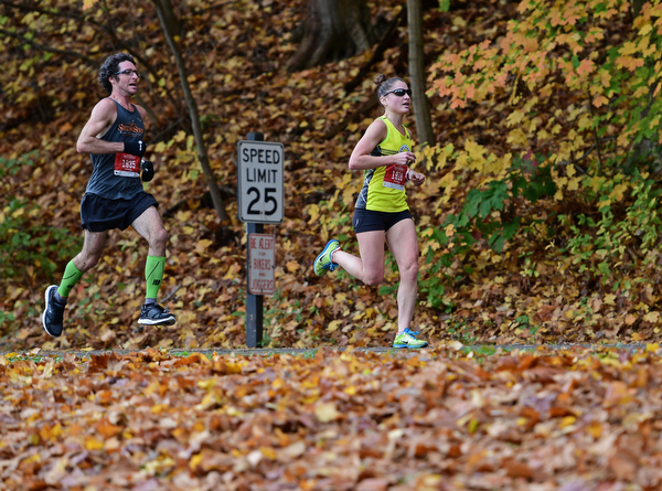YOUNGSTOWN, OHIO - OCTOBER 23, 2016: Jonathan Scooby Bolha and Erin Webster run on West Glacier Drive inside Mill Creek Park during the Peace Race, Sunday morning. DAVID DERMER | THE VINDICATOR