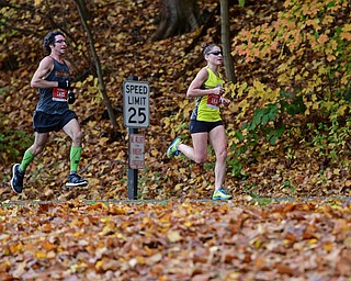 YOUNGSTOWN, OHIO - OCTOBER 23, 2016: Jonathan Scooby Bolha and Erin Webster run on West Glacier Drive inside Mill Creek Park during the Peace Race, Sunday morning. DAVID DERMER | THE VINDICATOR