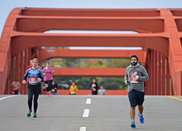 YOUNGSTOWN, OHIO - OCTOBER 23, 2016: Daniel Catollo leads a pack of runners across the Market Street bridge as they run toward the finish line during the Peace Race, Sunday morning. DAVID DERMER | THE VINDICATOR