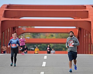 YOUNGSTOWN, OHIO - OCTOBER 23, 2016: Daniel Catollo leads a pack of runners across the Market Street bridge as they run toward the finish line during the Peace Race, Sunday morning. DAVID DERMER | THE VINDICATOR
