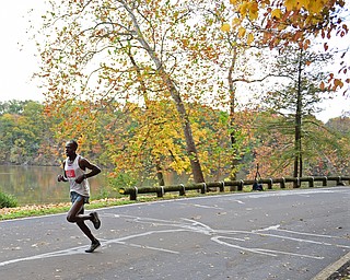 YOUNGSTOWN, OHIO - OCTOBER 23, 2016: James Kibet runs on West Glacier Drive inside Mill Creek Park during the Peace Race, Sunday morning. DAVID DERMER | THE VINDICATOR