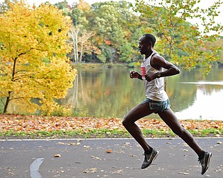 YOUNGSTOWN, OHIO - OCTOBER 23, 2016: James Kibet runs on West Glacier Drive inside Mill Creek Park during the Peace Race, Sunday morning. DAVID DERMER | THE VINDICATOR