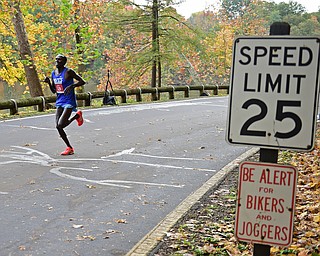 YOUNGSTOWN, OHIO - OCTOBER 23, 2016: Julius Kiptoo runs on West Glacier Drive inside Mill Creek Park during the Peace Race, Sunday morning. DAVID DERMER | THE VINDICATOR
