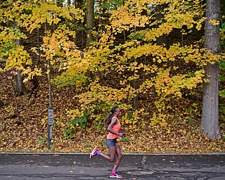 YOUNGSTOWN, OHIO - OCTOBER 23, 2016: Veronicah Maina runs on West Glacier Drive inside Mill Creek Park during the Peace Race, Sunday morning. DAVID DERMER | THE VINDICATOR