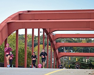 YOUNGSTOWN, OHIO - OCTOBER 23, 2016: Courtney Poullas of Youngstown leads a pack of runners across the Market Street bridge as they run toward the finish line during the Peace Race, Sunday morning. DAVID DERMER | THE VINDICATOR