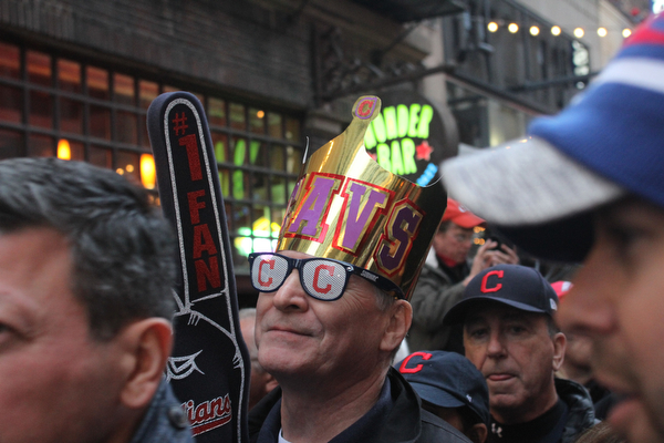 Nikos Frazier | The Vindicator..A man in a Cavs crown walks through the 4th St. District before the Indians take on the Cubs at Progressive Field on Tuesday, Oct. 25, 2016.