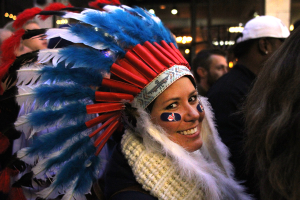 Nikos Frazier | The Vindicator..A woman wearing an Indian headdress walks though the 4th St. District before the Indians take on the Cubs at Progressive Field on Tuesday, Oct. 25, 2016.