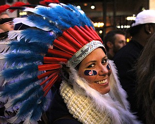 Nikos Frazier | The Vindicator..A woman wearing an Indian headdress walks though the 4th St. District before the Indians take on the Cubs at Progressive Field on Tuesday, Oct. 25, 2016.