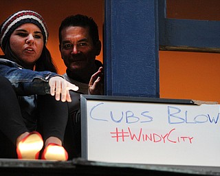 Nikos Frazier | The Vindicator..Fans cheer on the Indians as they sit on window sills in the 4th St. District before the Indians take on the Cubs at Progressive Field on Tuesday, Oct. 25, 2016.