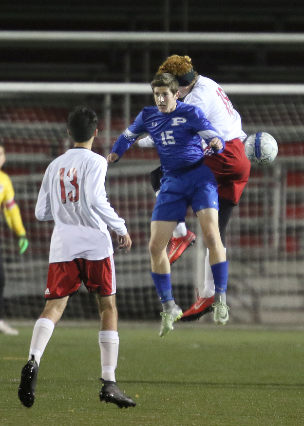  .          ROBERT  K. YOSAY | THE VINDICATOR..Polands #15  Matthew Slepski - and Canfields #18  Sam Accordino battle for the ball as #13 Alec Simone looks on..Canfield vs Poland Soccer  District II Semifinals at Canfield..-30-