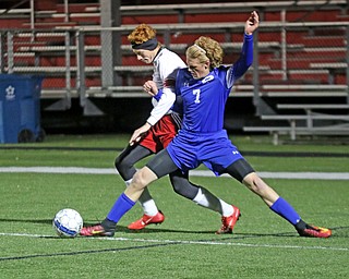  .          ROBERT  K. YOSAY | THE VINDICATOR..Poland #7 Reed McCreery  stretches as he keeps the ball from #18 Sam Accordino  (captain)..Canfield vs Poland Soccer  District II Semifinals at Canfield..-30-