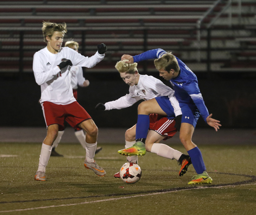 .          ROBERT  K. YOSAY | THE VINDICATOR..#5 Marcus Trevis and  #10 Phil Stanic battle for the ball late in the first half --looking on is #11  Brendon Maurer ..Canfield vs Poland Soccer  District II Semifinals at Canfield..-30-