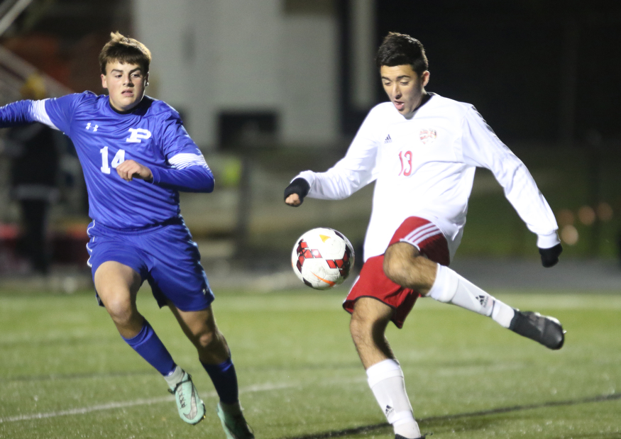  .          ROBERT  K. YOSAY | THE VINDICATOR..#13 Alec Simone takes the ball at midfield  as Poland #14 Marcus Romeo..Canfield vs Poland Soccer  District II Semifinals at Canfield..-30-