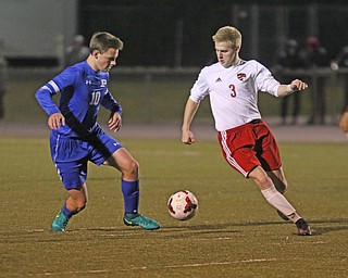  .          ROBERT  K. YOSAY | THE VINDICATOR..Poland #10 Evan Rumble -Captain-  tries to take the ball #3 Tanner English.  Tanner scored two goals in the first half for Canfield..Canfield vs Poland Soccer  District II Semifinals at Canfield..-30-