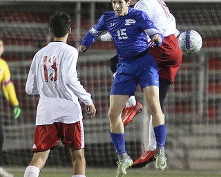  .          ROBERT  K. YOSAY | THE VINDICATOR..Polands #15  Matthew Slepski - and Canfields #18  Sam Accordino battle for the ball as #13 Alec Simone looks on..Canfield vs Poland Soccer  District II Semifinals at Canfield..-30-