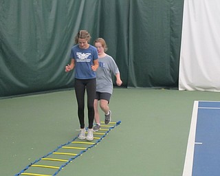 Neighbors | Alexis Bartolomucci.A buddy and an athlete exercised on Sept. 24 at the Boardman Tennis Center before they started playing tennis for the Buddy Up Tennis program.