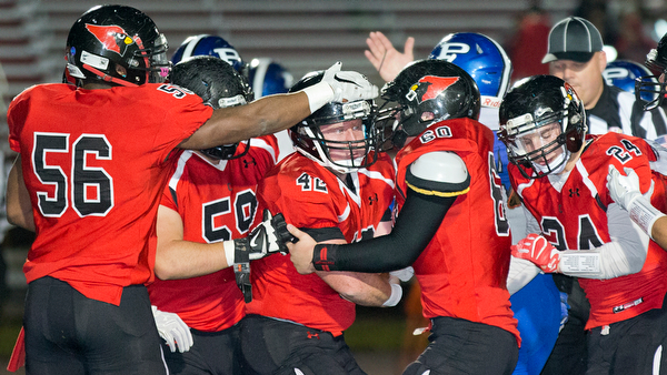 MICHAEL G TAYLOR | THE VINDICATOR- 10-28-16- 1st qtr, after his interception, Canfield's #42 Cody Holland celebrates with his teammates. Poland Bulldogs vs Canfield Cardinals at Bob Dove Field in Canfield, OH.