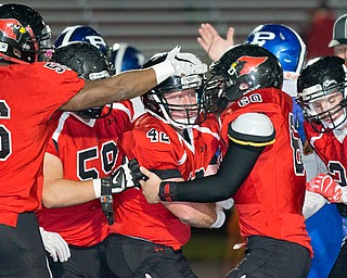 MICHAEL G TAYLOR | THE VINDICATOR- 10-28-16- 1st qtr, after his interception, Canfield's #42 Cody Holland celebrates with his teammates. Poland Bulldogs vs Canfield Cardinals at Bob Dove Field in Canfield, OH.