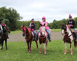 Neighbors | Abby Slanker.Riders and horses participating in the third annual Survivor Run, decked out in pink, prepared to hit the trail at Buckeye Horse Farm on Oct. 1.