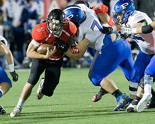 MICHAEL G TAYLOR | THE VINDICATOR- 10-28-16- 1st qtr, Canfield's #7 Jake Cummings runs for a 4 yard gain as Poland's #74 Jared Carcelli makes the tackle. Poland Bulldogs vs Canfield Cardinals at Bob Dove Field in Canfield, OH.