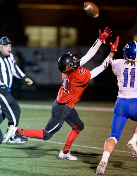 MICHAEL G TAYLOR | THE VINDICATOR- 10-28-16- 2nd qtr, Canfield's #41 Matt Zaremski hauls in a 40 yard td pass as Poland's #11 Alex Kotouch provides the coverage. Poland Bulldogs vs Canfield Cardinals at Bob Dove Field in Canfield, OH.
