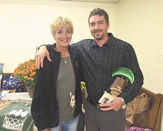SPECIAL TO THE VINDICATOR
Volney Rogers Emerald Pierogi Award was recently presented to Joshua Rupe by Anna Marie Namath, last year’s winner. Above are Joshua Rupe and his mother, Kate Rupe. The ceremony took place Sept. 28 and recognizes outstanding landscaping and renovation of a residence in the Rocky Ridge area. The award embodies the spirit of Volney Rogers. Just as he preserved the natural beauty of Mill Creek Park, so do neighbors try to keep Rocky Ridge beautiful. On top of that, the Emerald Pierogi celebrates the ethnic cultures that once took root in the neighborhood.