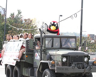 Nikos Frazier | The Vindicator..Pete the Penguin rides on the Lyden Oil float with YSU Cheerleaders at the 2016 Youngstown State University Homecoming on Saturday, Oct. 29, 2016.