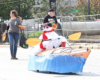 Nikos Frazier | The Vindicator..A ghost paddles a kayak up fifth avenue at the 2016 Youngstown State University Homecoming on Saturday, Oct. 29, 2016. The kayak float is sponsored by the Friends of the Mahoning River.