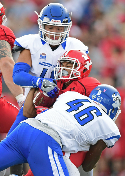 YOUNGSTOWN, OHIO - OCTOBER 29, 2016: Jody Webb #20 of YSU is brought down by Jonas Griffith #46 and Katrell Moss #40 of Indiana State during the first half of their game Saturday afternoon at Stambaugh Stadium. YSU 13-10. DAVID DERMER | THE VINDICATOR