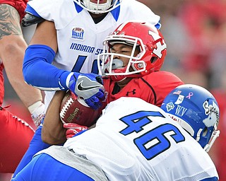 YOUNGSTOWN, OHIO - OCTOBER 29, 2016: Jody Webb #20 of YSU is brought down by Jonas Griffith #46 and Katrell Moss #40 of Indiana State during the first half of their game Saturday afternoon at Stambaugh Stadium. YSU 13-10. DAVID DERMER | THE VINDICATOR