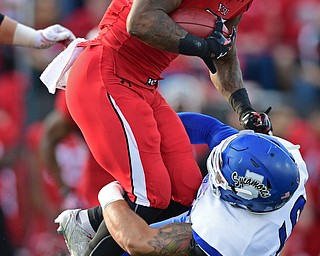 YOUNGSTOWN, OHIO - OCTOBER 29, 2016: Martin Ruiz #29 of YSU runs through would be tackler Katrell Moss #40 of Indiana State during the first half of their game Saturday afternoon at Stambaugh Stadium. YSU 13-10. DAVID DERMER | THE VINDICATOR