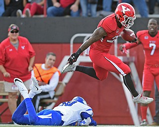YOUNGSTOWN, OHIO - OCTOBER 29, 2016: Martin Ruiz #29 of YSU hurdles over Kevin Beacham #30 of Indiana State during the first half of their game Saturday afternoon at Stambaugh Stadium. YSU 13-10. DAVID DERMER | THE VINDICATOR