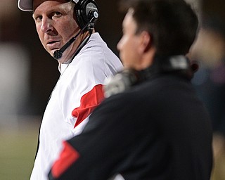 YOUNGSTOWN, OHIO - OCTOBER 29, 2016: Head coach Bo Pelini glares at wide receivers coach Brian Crist on the sideline during the second half of their game Saturday afternoon at Stambaugh Stadium. YSU 13-10. DAVID DERMER | THE VINDICATOR