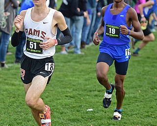 BOARDMAN, OHIO - OCTOBER 29, 2016: Palmer Cameron of Mineral Ridge runs in front of Demetrius Snellenberger of East Canton during the Division 3 Northeast Ohio Regional Cross Country race at Boardman High School. DAVID DERMER | THE VINDICATOR