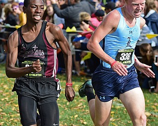 BOARDMAN, OHIO - OCTOBER 29, 2016: Chris Butler of Boardman and Zach Fresenko of Louisville run to the finish line during the Division 1 Northeast Ohio Regional Cross Country race at Boardman High School. DAVID DERMER | THE VINDICATOR
