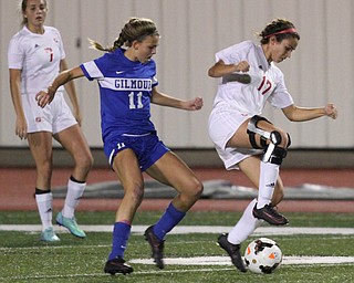 Solon, Ohio: Tuesday, Nov. 1, 2016..Mooney's Lizzie Philibin(17) dribbles around Gilmour's Annie Greene(11) in the first half as Cardinal Mooney High School takes on Gilmour Academy at the Division III girls soccer regional semifinal at Stewart Field in Solon, Ohio on Tuesday, Nov. 1, 2016...(Nikos Frazier | The Vindicator