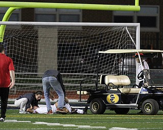Solon, Ohio: Tuesday, Nov. 1, 2016..Mooney's Lizzie Philibin(17) is assisted my the trainers after a bad collision in the first half as Cardinal Mooney High School takes on Gilmour Academy at the Division III girls soccer regional semifinal at Stewart Field in Solon, Ohio on Tuesday, Nov. 1, 2016...(Nikos Frazier | The Vindicator