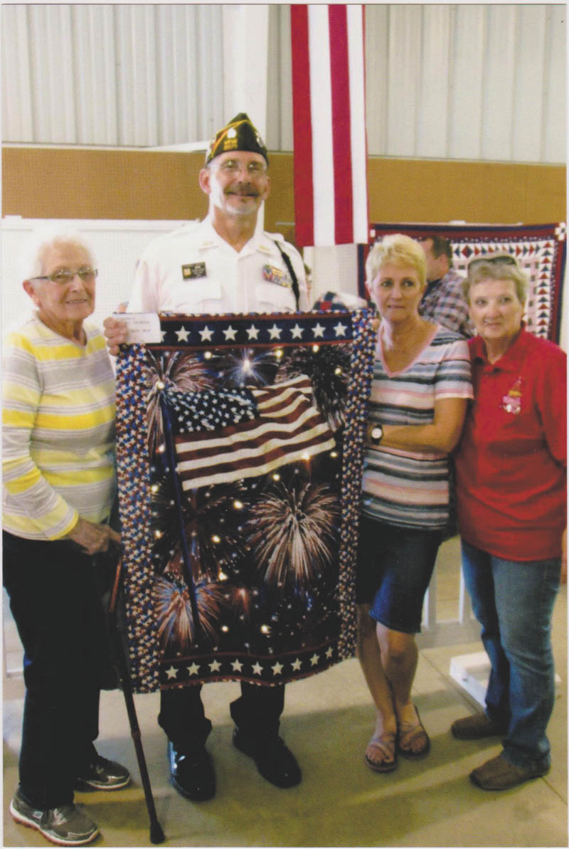 SPECIAL TO THE VINDICATOR
Veterans of Foreign Wars Post 9571 life-member Tom Check was one of the veterans honored recently at the Columbiana Veterans and 9/11 observance ceremony. He received a quilted wall-hanging made by local resident Sandie Campbell in recognition of his service. Check served in the U.S. Air Force during Vietnam, Desert Storm and Iraqi Freedom. He has received a number of military commendations and medals. Those attending the ceremony, from left, are Shirley Check, his mother; Check; Cindy Baker, his sister; and Sharon Cope, event coordinator.