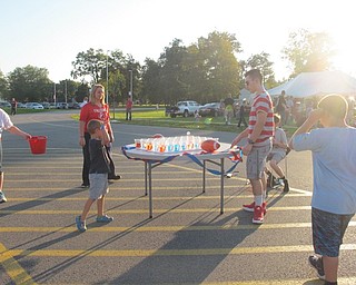 Neighbors | Alexis Bartolomucci.An Austintown student threw a ping pong ball into cups filled with water to win a prize during the Austintown Intermediate School and Elementary School pep rally on Oct. 6.