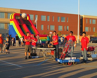 Neighbors | Alexis Bartolomucci.Students from the Austintown Fitch High School Robotics Team brought their robots to the pep rally on Oct. 6 to show to the families who attended and use the robots to do a t-shirt toss.