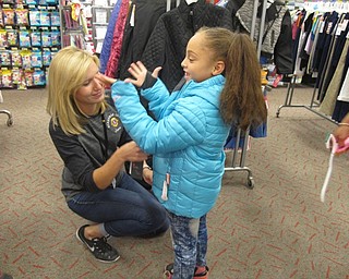 Neighbors | Alexis Bartolomucci.Boardman Lions Club member, Jana Coffin, helps Tavia Williams try on a coat at Target on Oct. 4 during the Coats for Kids project.