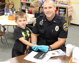 Neighbors | Abby Slanker.Canfield Police Department School Resource Officer Steve Garstka fingerprinted a Hilltop Elementary School kindergartner for the Child Safety Fingerprint ID Kits the department provided for kindergartners Sept. 28.