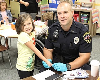 Neighbors | Abby Slanker.A Hilltop Elementary School kindergartner took her turn getting fingerprinted by Canfield Police Department School Resource Officer Steve Garstka for the Child Safety Fingerprint ID Kits the department provided for all kindergartners Sept. 28.