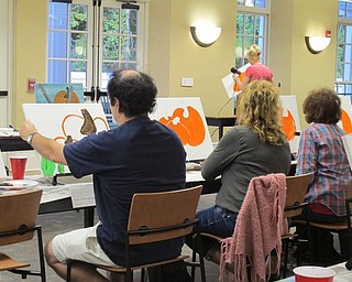 Neighbors | Alexis Bartolomucci.People painted pumpkin pictures during the painting event on Oct. 3 at the Poland library.