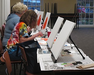 Neighbors | Alexis Bartolomucci.Guests worked on painting their pumpkin pictures at the painting event at the Poland library on Oct. 3.
