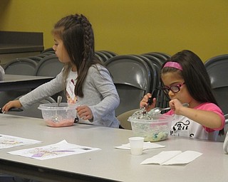 Neighbors | Alexis Bartolomucci.Gabby and Ana mix together their mashed potatoes with food coloring to make different colored mashed potatoes during Sprout Club on Oct. 13 at Fellows Riverside Gardens.