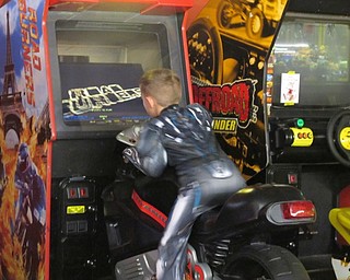 Neighbors | Alexis Bartolomucci.One of the children at Austintown Bounce's Halloween party on Oct. 21 played a game until the parade started.