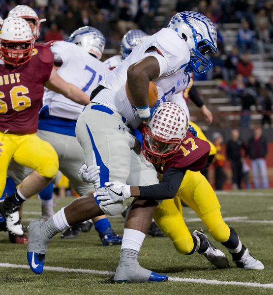 MICHAEL G TAYLOR | THE VINDICATOR- 11-0416- 1st qtr, Mooney's #17 Darrell Jackson brings down Hubbard's #5 Rafael Morales for a 1 yard loss . OHSAA D4 Football Playoffs Hubbard Eagles vs Cardinal Mooney Cardinals at Stambaugh Stadium, YSU in Youngstown, OH