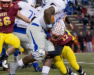 MICHAEL G TAYLOR | THE VINDICATOR- 11-0416- 1st qtr, Mooney's #17 Darrell Jackson brings down Hubbard's #5 Rafael Morales for a 1 yard loss . OHSAA D4 Football Playoffs Hubbard Eagles vs Cardinal Mooney Cardinals at Stambaugh Stadium, YSU in Youngstown, OH